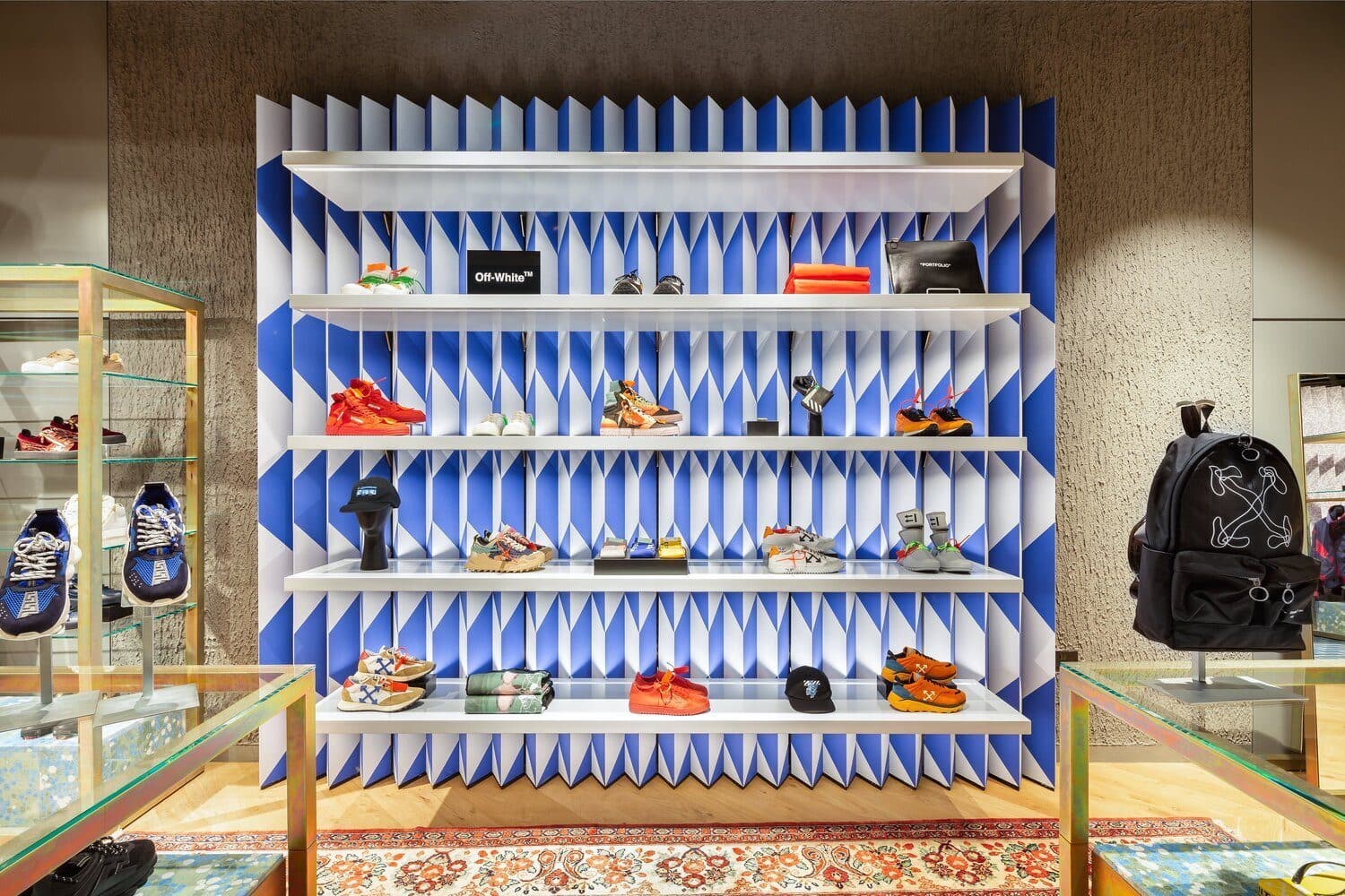 A designer sneaker and accessories display at Flannels, shot by Biztour