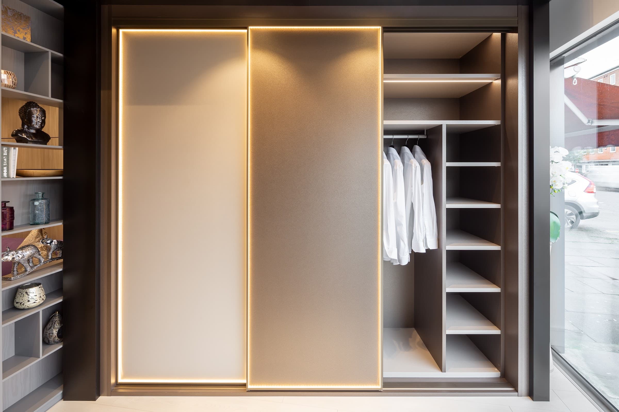 An illuminated fitted wardrobe display at the Highlux showroom