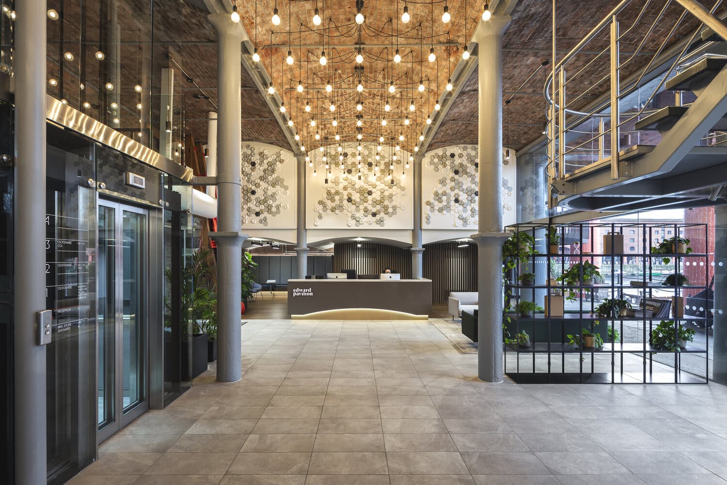 A brick-vaulted lobby and staircase in a converted warehouse building, photographed by Biztour