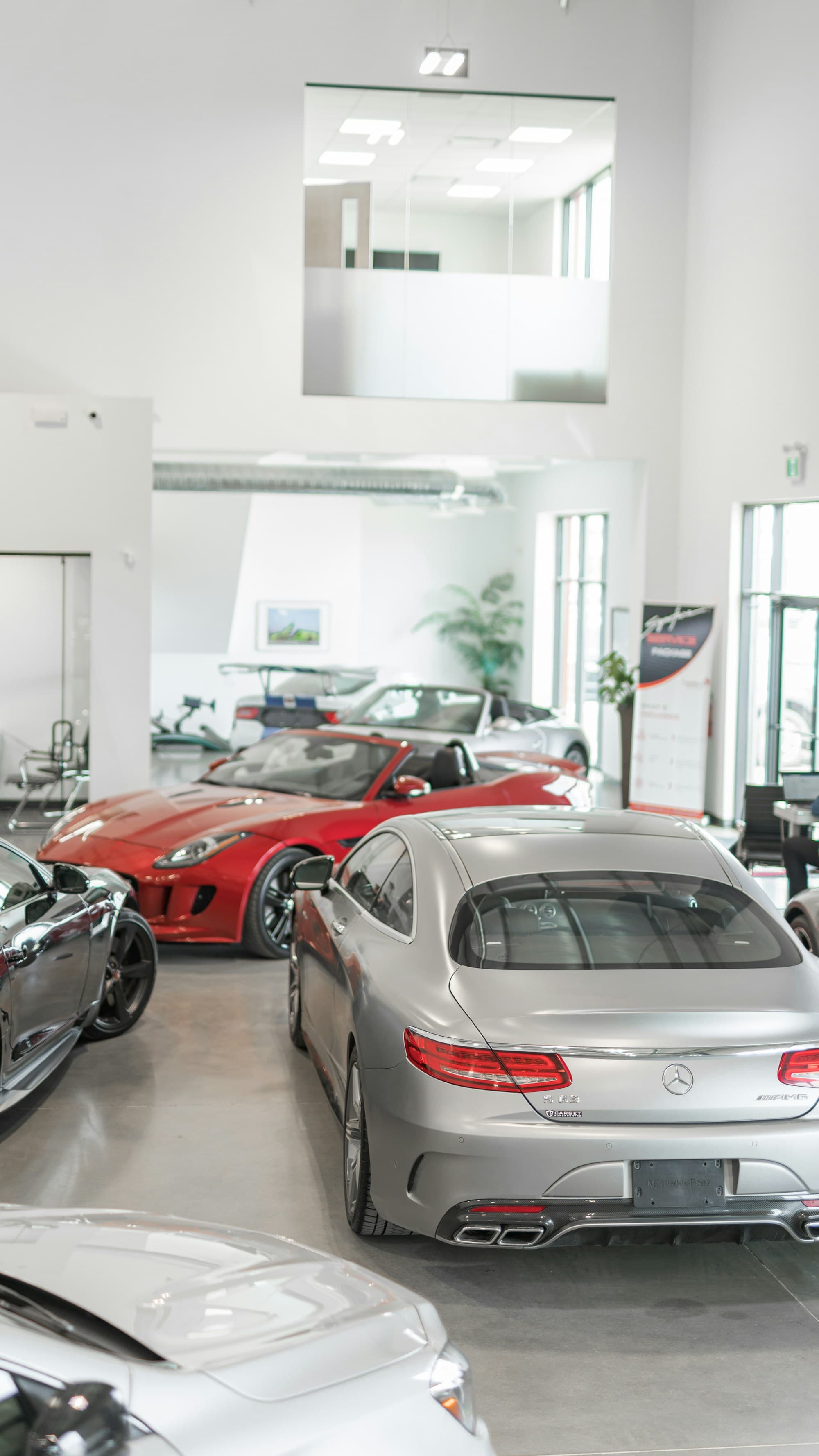 A car dealership showroom floor with several vehicles on display