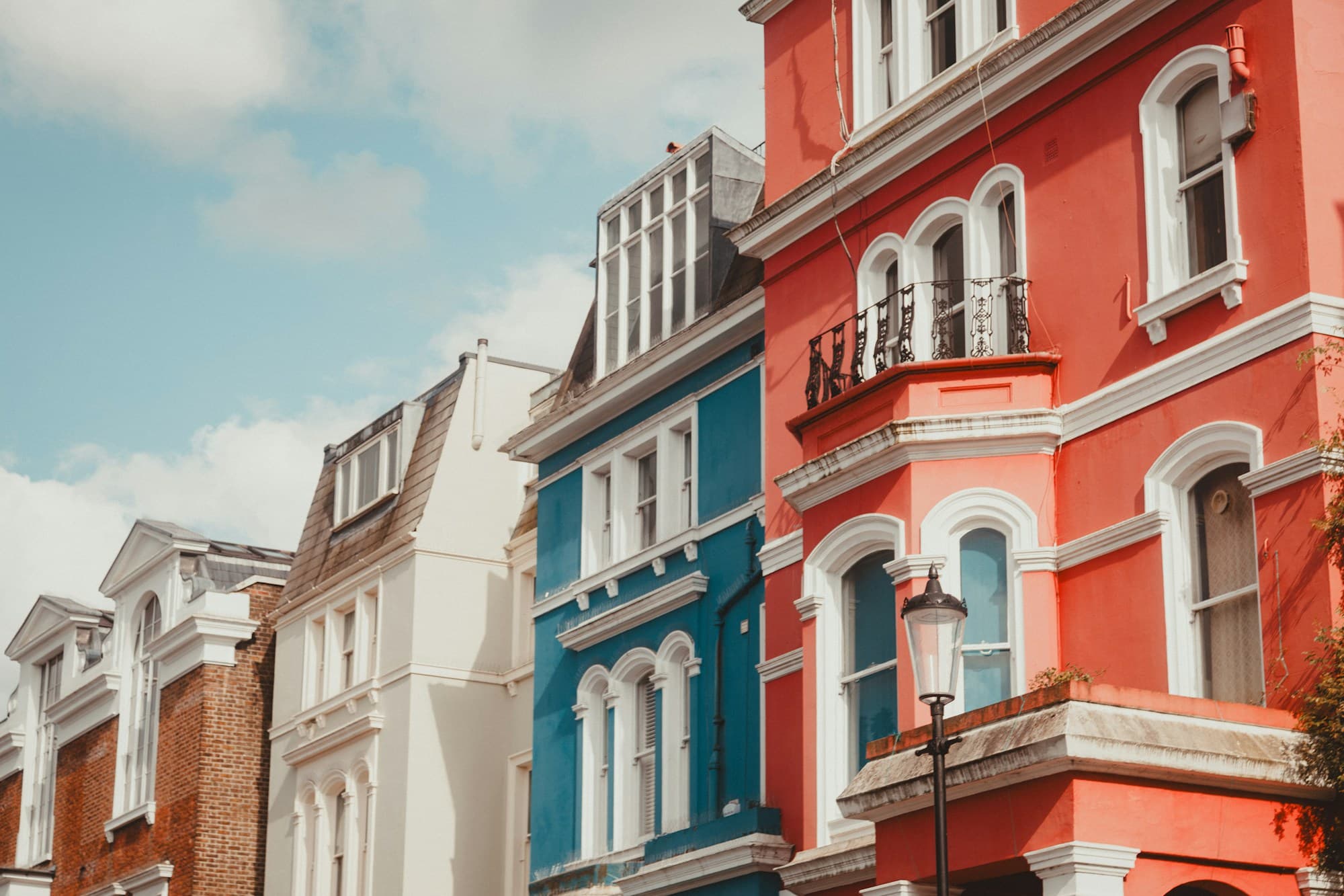 A row of colourful period shopfronts on a UK high street