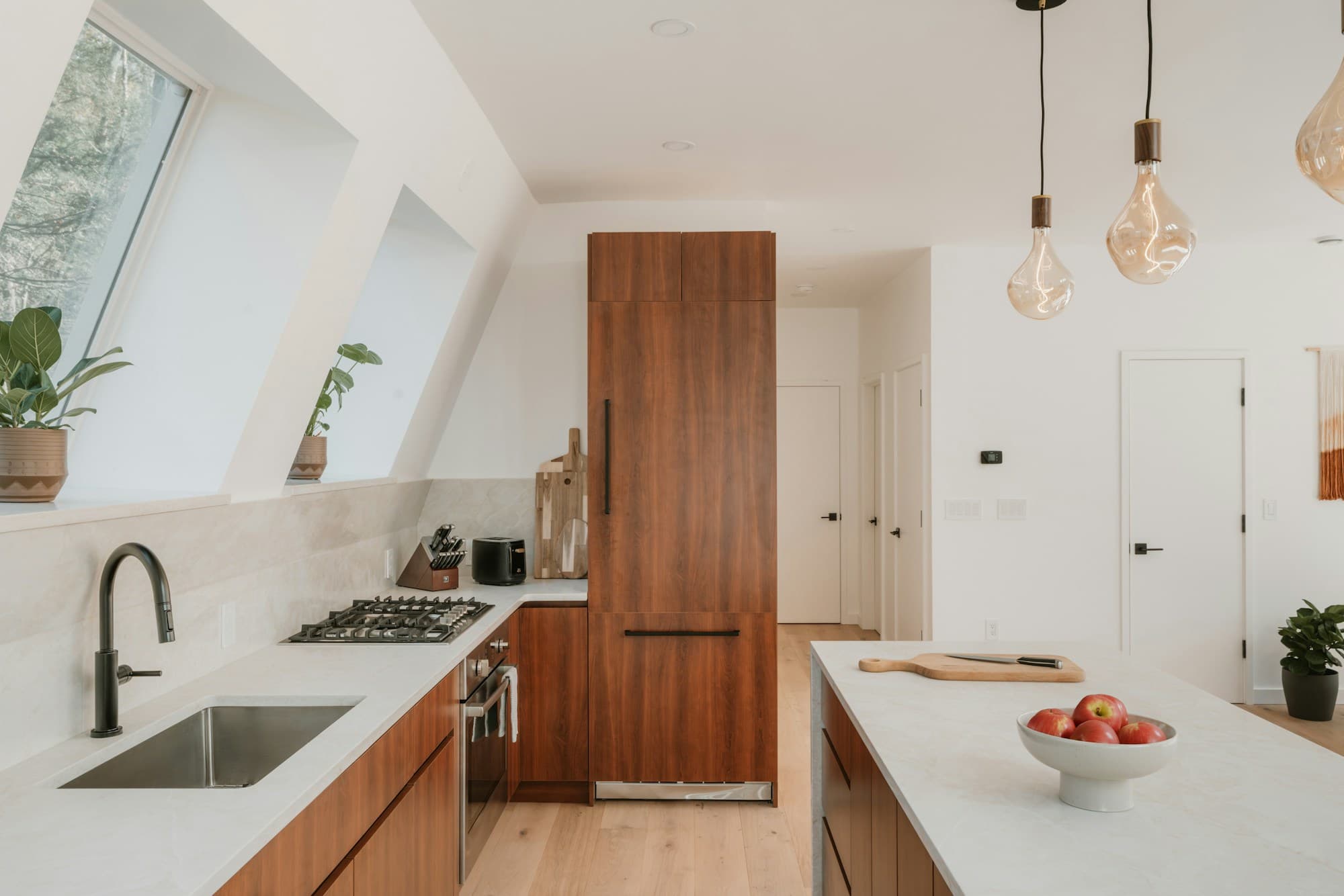 A modern fitted kitchen with a central island and pendant lighting