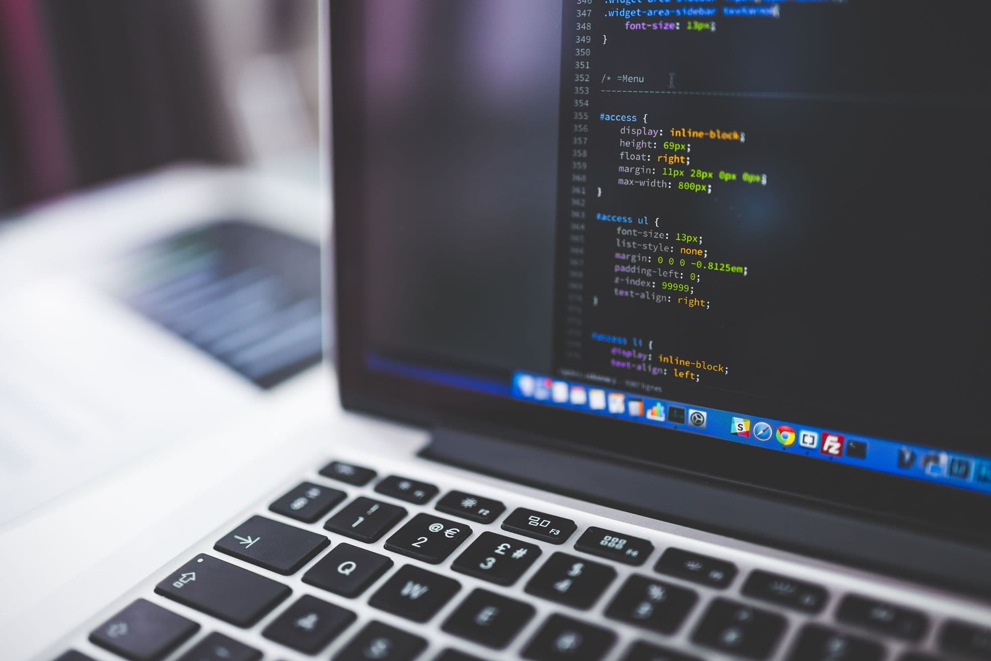 A laptop with a code editor open on the screen