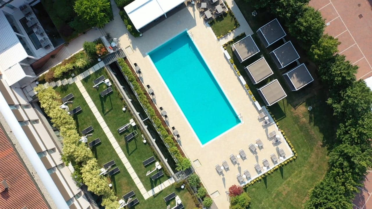 Aerial view of a pool and grounds, filmed by Biztour